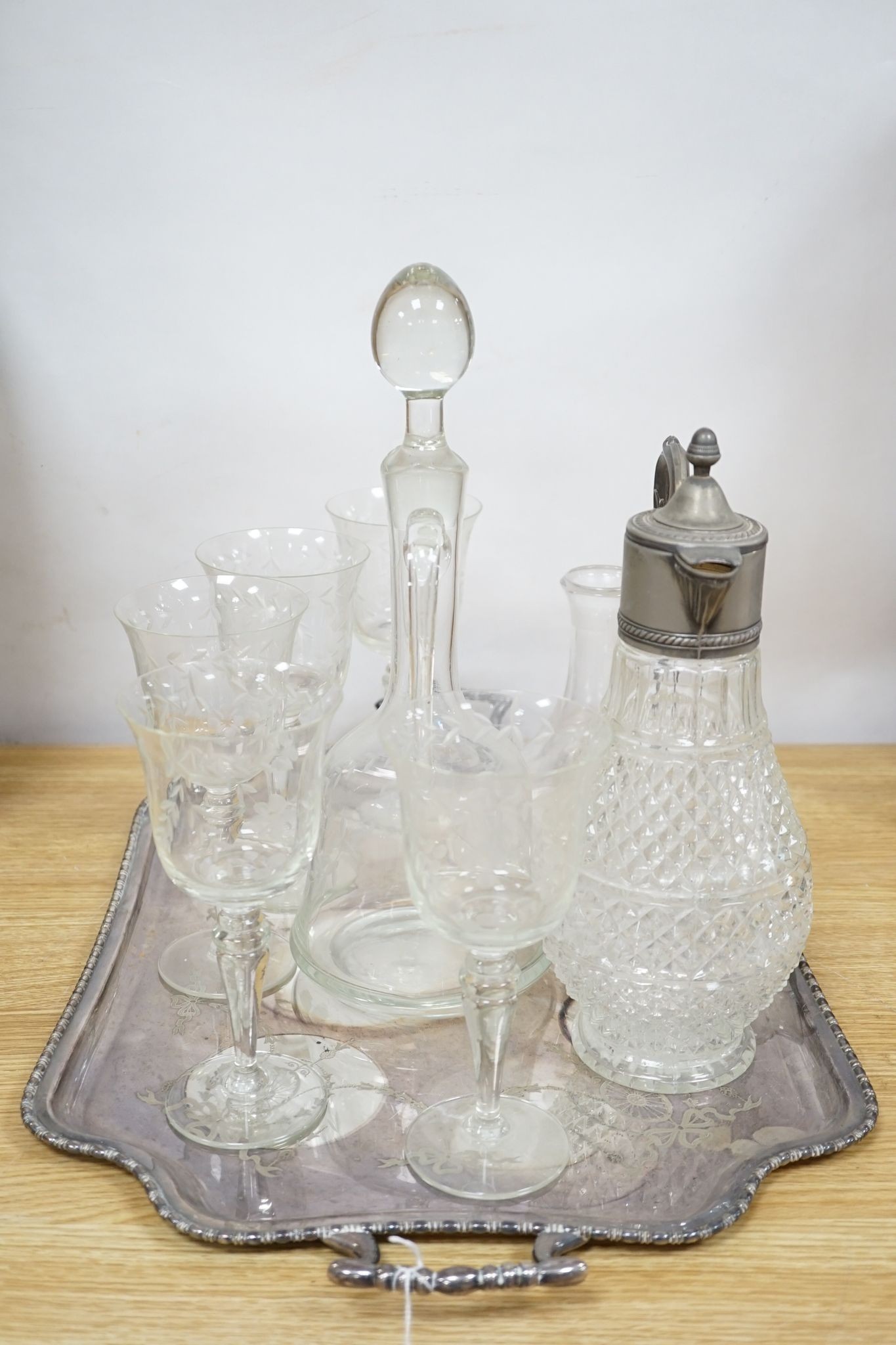 A plated two handled tea tray, a claret jug, two decanters and five glasses (9)